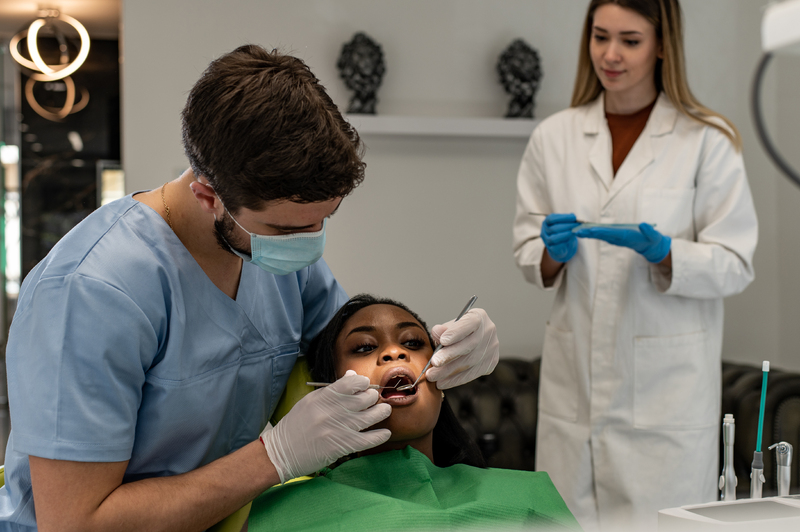 dentist-providing-dental-care-treatment-to-a-afric-2025-04-01-13-22-29-utc-1